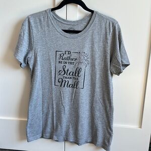 Grey tee shirt with text: “I’d rather be at the stall than the mall”